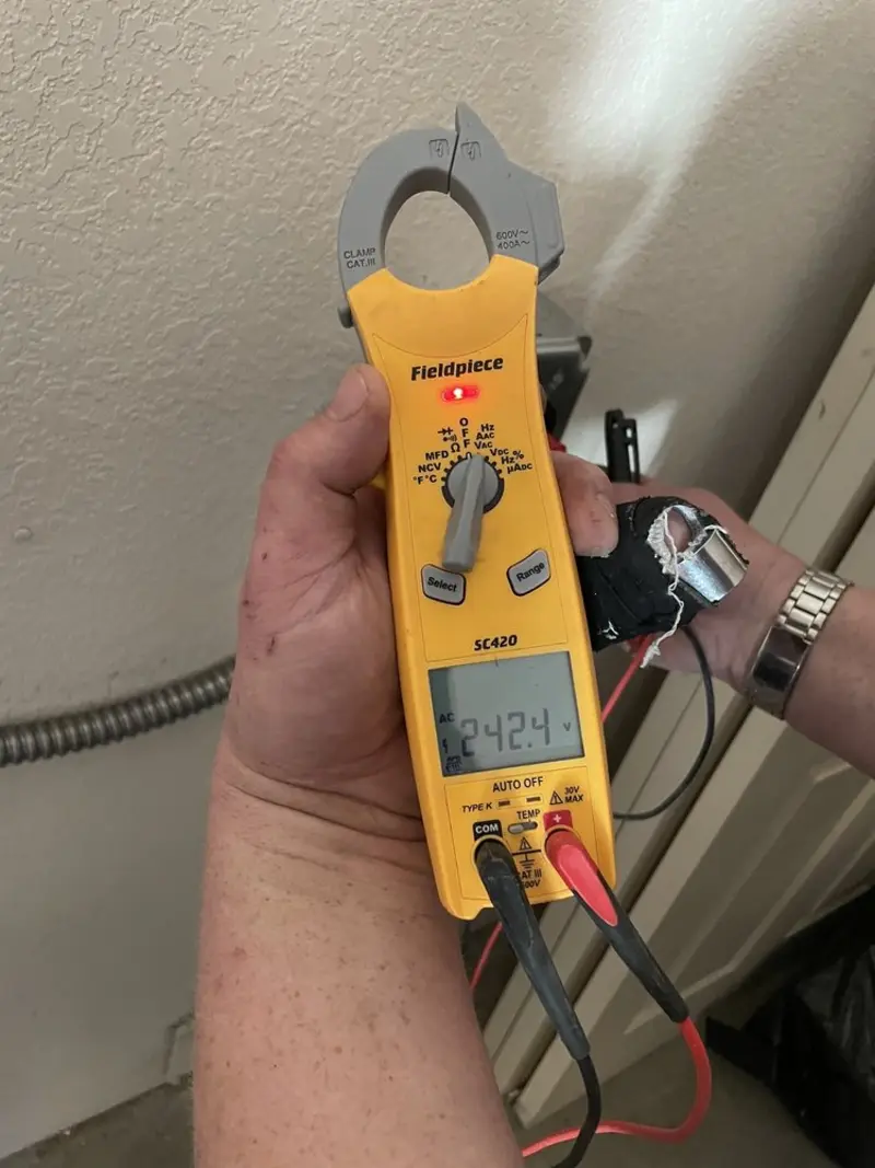 Voltage testing with clamp meter during Recessed Lighting Installation in Summit